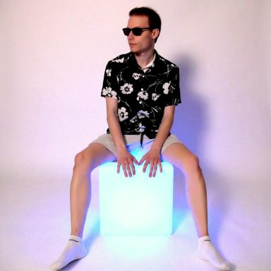 Joshy Flavour sitting on top of a blue LED light cube.